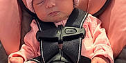 Delilah is registered to the contest to win money with this photo: baby, car_seat, child, closed_eyes, cozy, cute, footed_pajamas, indoor, infant, knit_hat, newborn, peaceful, pink_hat, pink_outfit, pom_pom, safety_harness, seat, sleeping, small_hands, soft_lighting