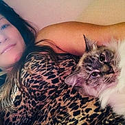 Coco Chanel joined the competition — help win amazing prizes! woman, cat, leopard_print, animal, pet, portrait, indoor, relaxing, feline, long_hair, smile, face, fur, cozy, comfort, resting, casual, human, closeup, laying_down