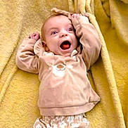 Lilah Jane joined the competition — help win amazing prizes! baby, infant, smiling, happy, face, clothing, sweater, bear_design, blanket, yellow, cute, child, young, lying_down, expression, indoor, soft_texture, warm_colors, hoodie, small_hands