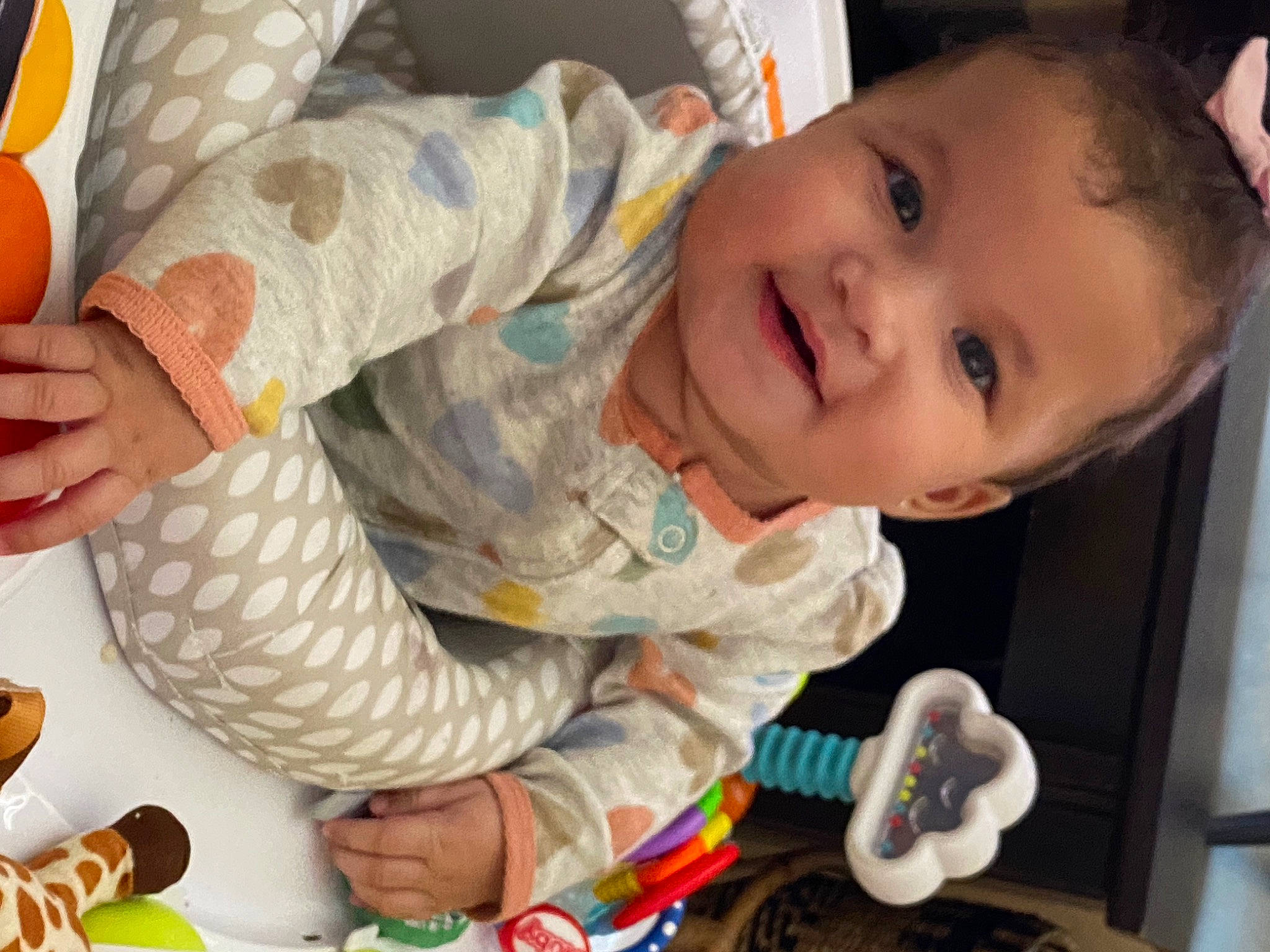 Kyla is registered to the contest to win money with this photo: baby, baby_products, baby_toddler_clothing, cheek, child, finger, fun, happy, head, mouth, nose, orange, person, room, sitting, skin, sleeve, smile, thumb, toddler