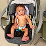 Kaili is registered to the contest to win money with this photo: baby, child, car_seat, diaper, toy, indoor, floor, blanket, chair, person, infant, seat, foot, hand, head, looking, expression, plastic_toy, clothing, furniture