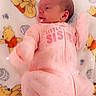 Athena is registered to the contest to win money with this photo: newborn, baby, infant, child, sleeping, lying_down, pink_outfit, onesie, face, portrait, blanket, teddy_bear, winnie_the_pooh, nursery, indoors, cozy, sparkles, soft_lighting, text_on_clothing, cute