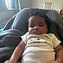 Bryson is registered to the contest to win money with this photo: arm, baby, bed, blanket, clothing, curly_hair, cute, face, hand, indoors, infant, person, portrait, relaxing, resting, skin, sleeping, soft_light, toddler, window