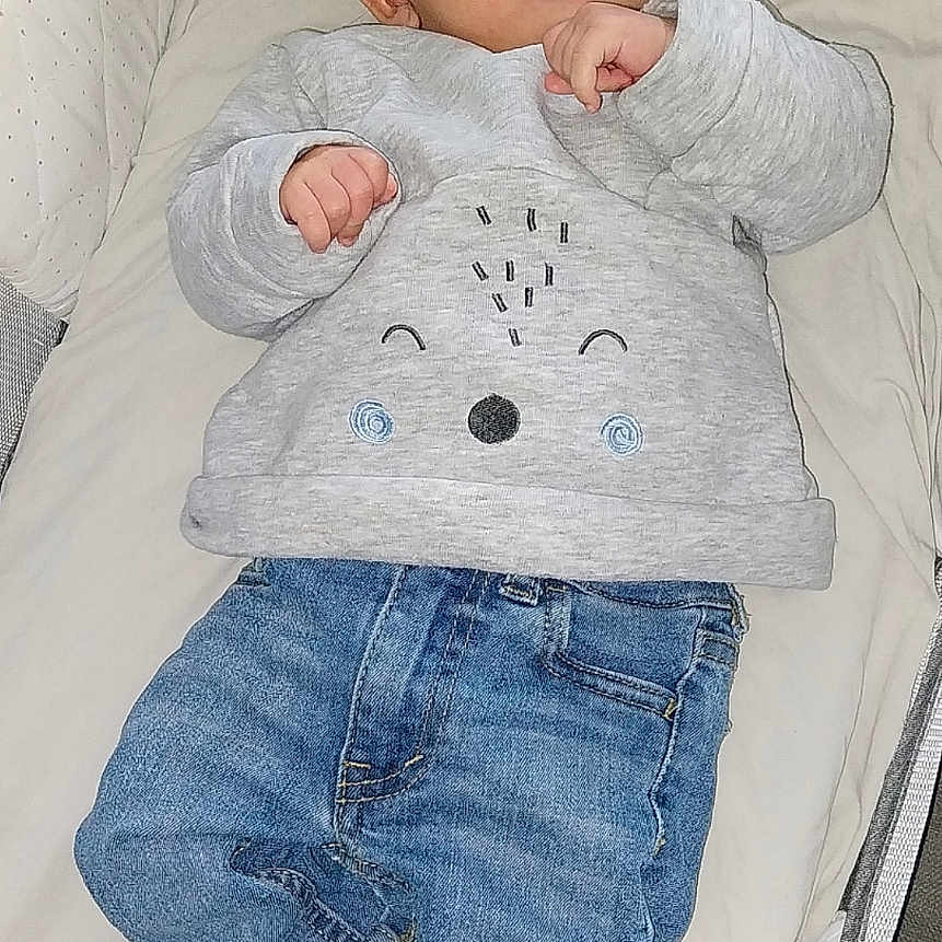 Nino a rejoint le concours — aidez-le/la à gagner de superbes lots ! baby, bassinet, blanket, casual_wear, child, clothing, comfortable, cushion, cute, face, indoors, infant, jeans, lying_down, portrait, resting, socks, sweater, yellow_toes, young_child