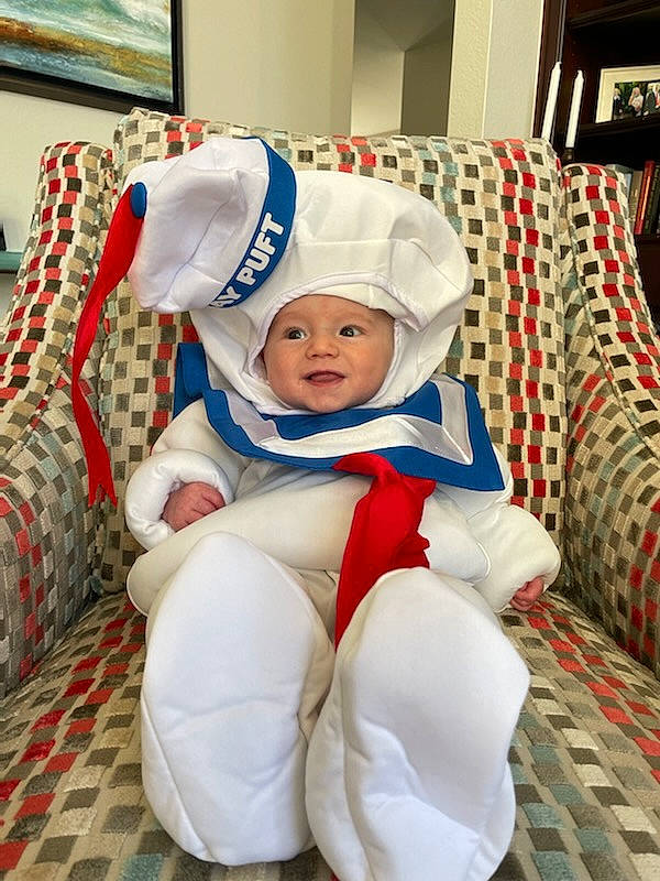 Sterling is registered to the contest to win money with this photo: baby, baby_toddler_clothing, cap, carmine, child, comfort, couch, event, fictional_character, foot, fun, happy, hat, headwear, holiday, lap, person, picture_frame, room, sitting