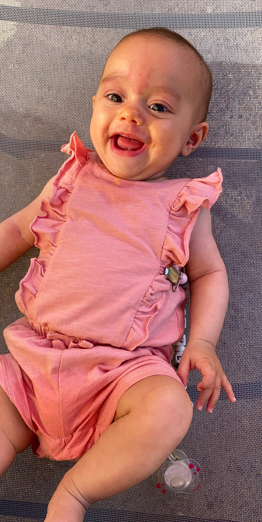 Myla participe au concours pour gagner de l'argent avec cette photo : baby, baby_toddler_clothing, cheek, child, facial_expression, person, pink, sitting, skin, smile, toddler