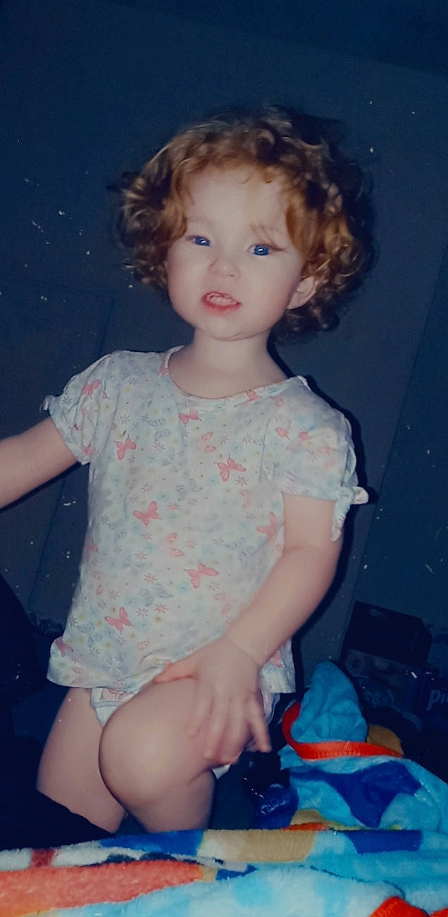 Annabella is registered to the contest to win money with this photo: baby_toddler_clothing, blue, cheek, day_dress, dress, hairstyle, head, human_body, iris, joint, lip, neck, organ, person, pink, ringlet, shoulder, skin, sleeve, standing