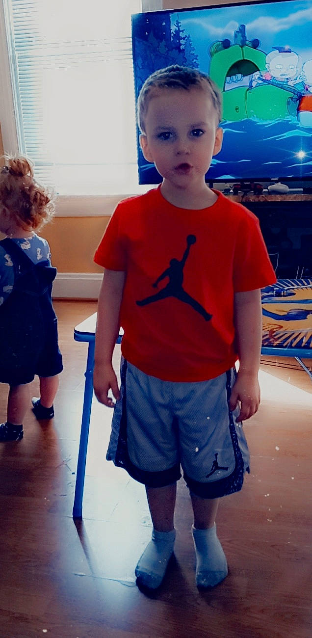 Dylan is registered to the contest to win money with this photo: active_shorts, azure, bermuda_shorts, blue, clothing, fashion, fun, hairstyle, human, joint, orange, organ, person, photograph, shorts, shoulder, skin, sleeve, standing, style