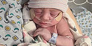 Tommy joined the competition — help win amazing prizes! newborn, baby, hospital, blanket, hat, oxygen_tube, sleeping, infant, medical, person, hand, arm, hospital_bed, patient, hospital_gown, footprint_pattern, resting, closeup, healthcare, wrapped