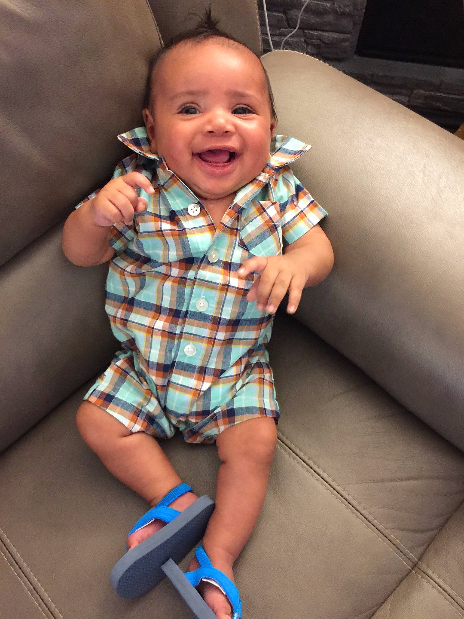 Tre is registered to the contest to win money with this photo: baby, cheek, child, design, leg, pattern, person, plaid, sitting, skin, smile, toddler