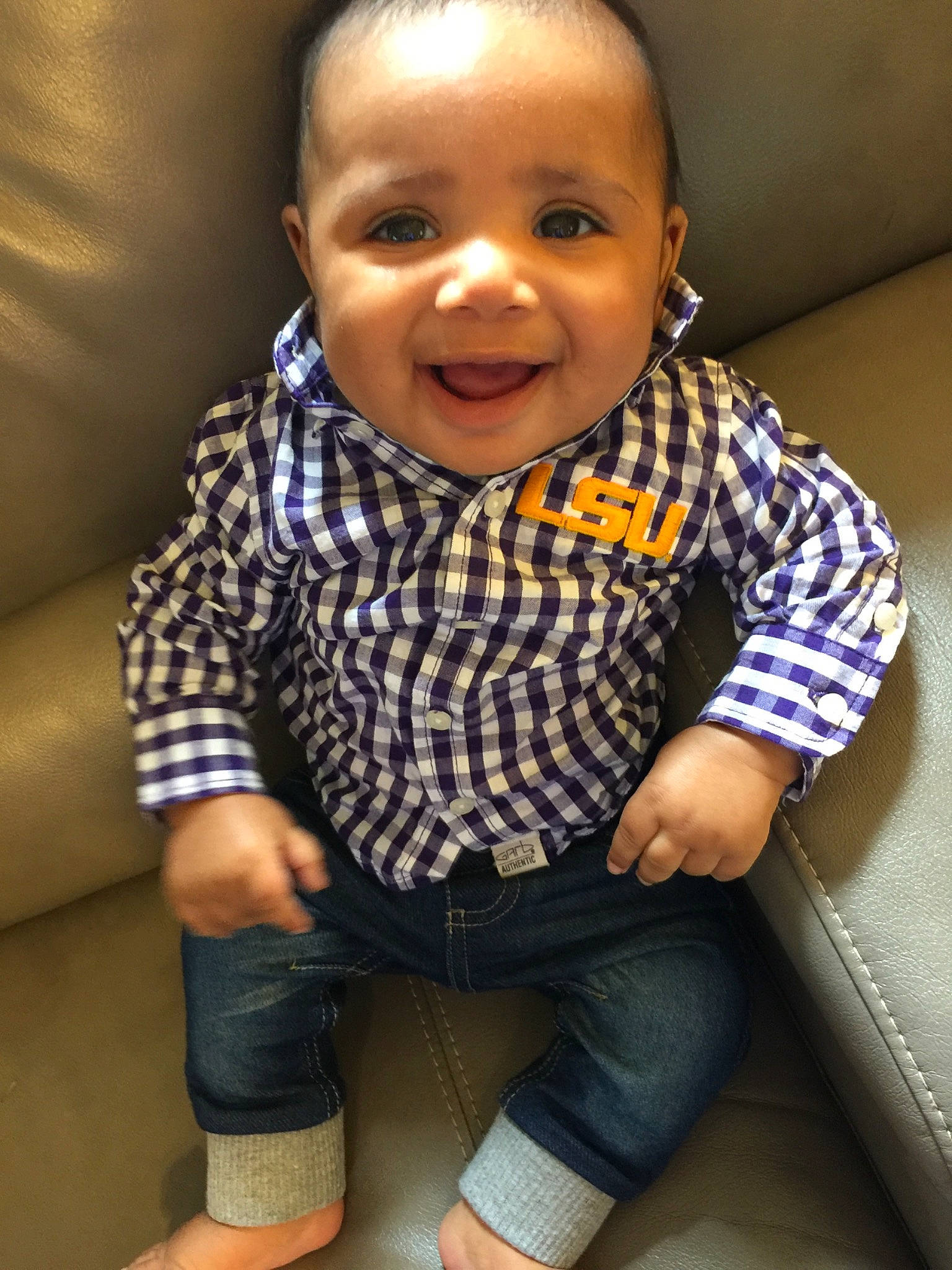 Tre is registered to the contest to win money with this photo: baby, baby_toddler_clothing, cheek, child, cool, face, facial_expression, head, lip, mouth, nose, outerwear, person, sitting, skin, smile, toddler