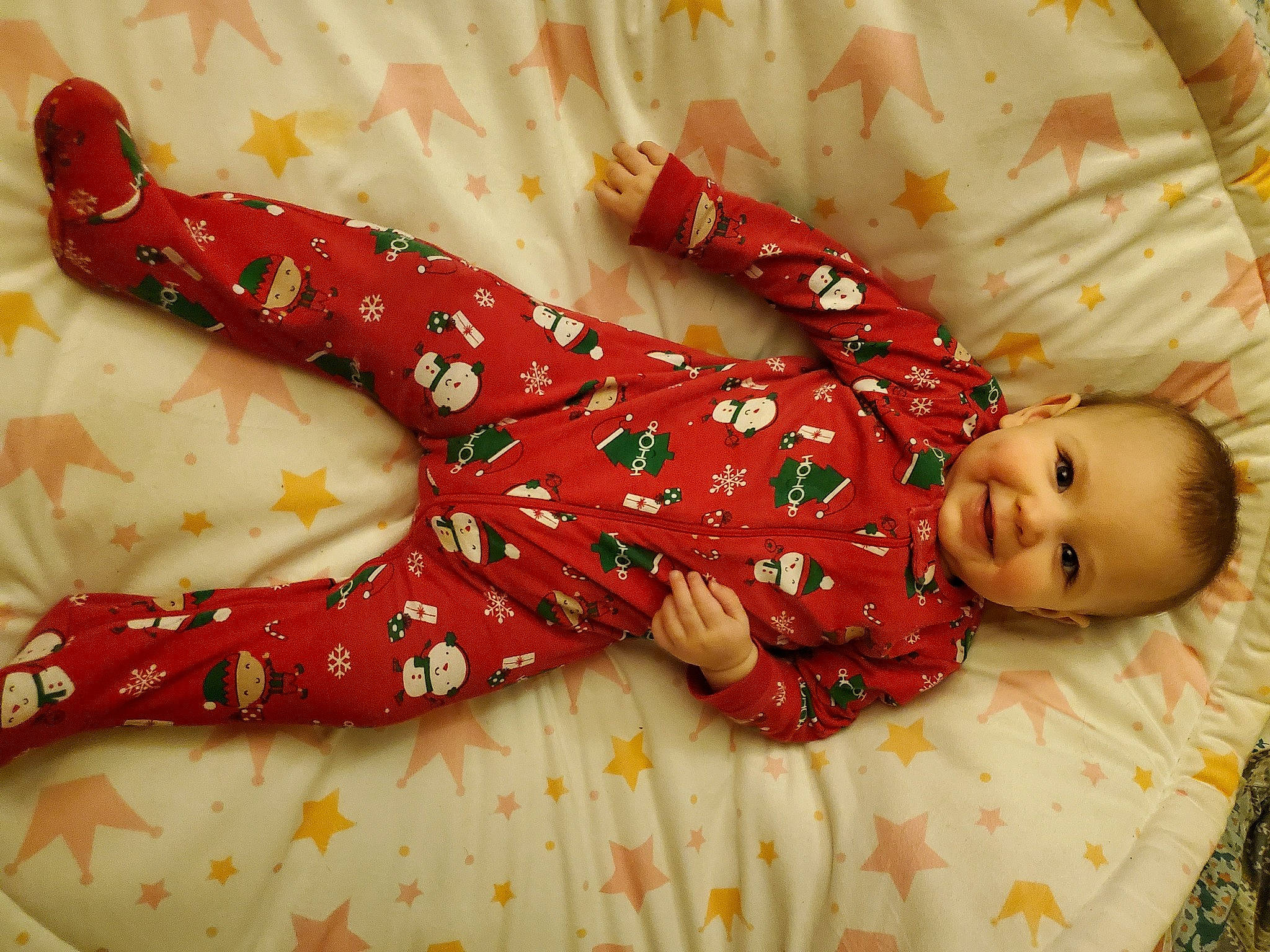 Ember is registered to the contest to win money with this photo: arm, baby, baby_toddler_clothing, bedding, carmine, child, comfort, dress, event, facial_expression, foot, human_body, human_leg, joy, leg, linens, pattern, person, skin, sleeve