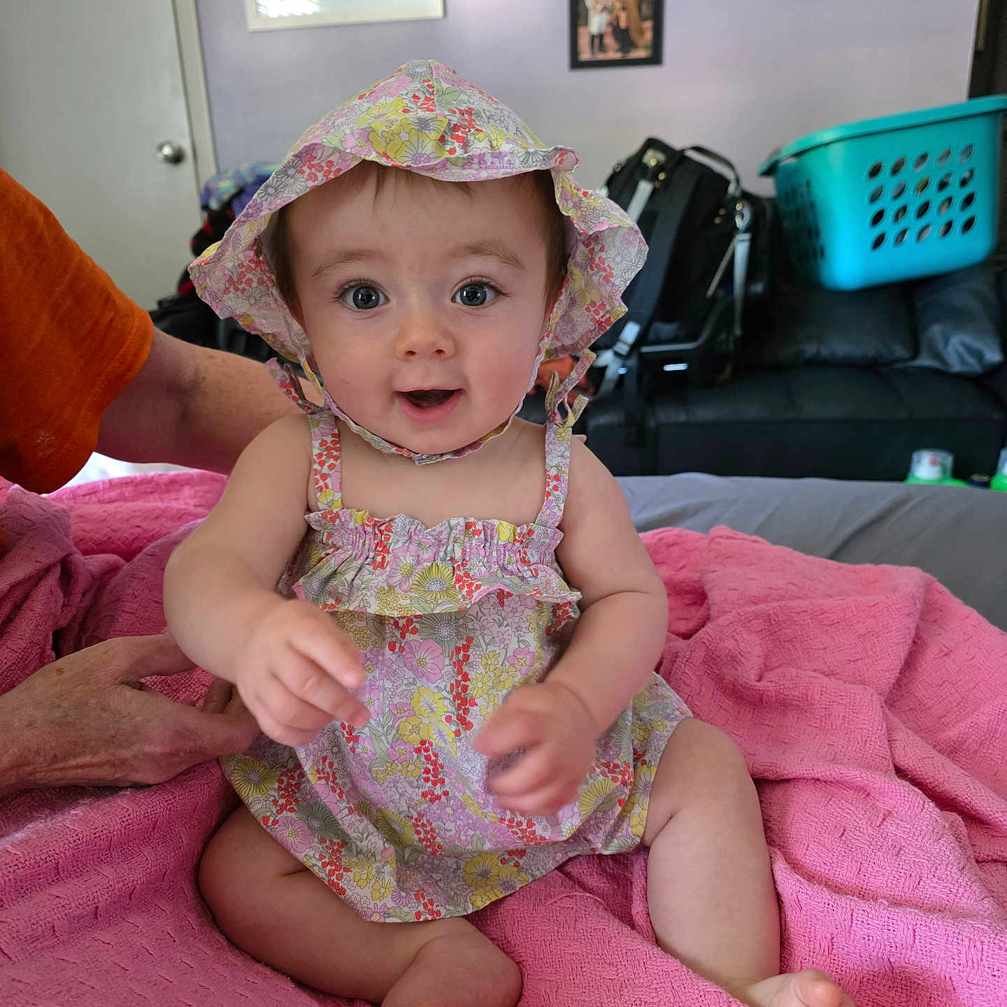 Zinnia joined the competition — help win amazing prizes! baby, child, couch, face, floral_dress, floral_hat, foot, hand, happy, home, indoor, infant, laundry_basket, person, photograph, pink_blanket, sitting, smiling, support, wall_art