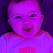 Scarlet joined the competition — help win amazing prizes! baby, child, face, smile, clothing, purple_light, infant, happy, cute, person, text_on_clothing, short_sleeves, young_child, portrait, indoors, bright_eyes, shirt, neon_light, closeup, joy