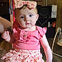 Scarlet joined the competition — help win amazing prizes! baby, child, girl, pink_clothing, headband, bow, sitting, indoor, tattoo, wood_paneling, furniture, skirt, blue_eyes, person, portrait, cute, holding_hand, decor, clock, photography