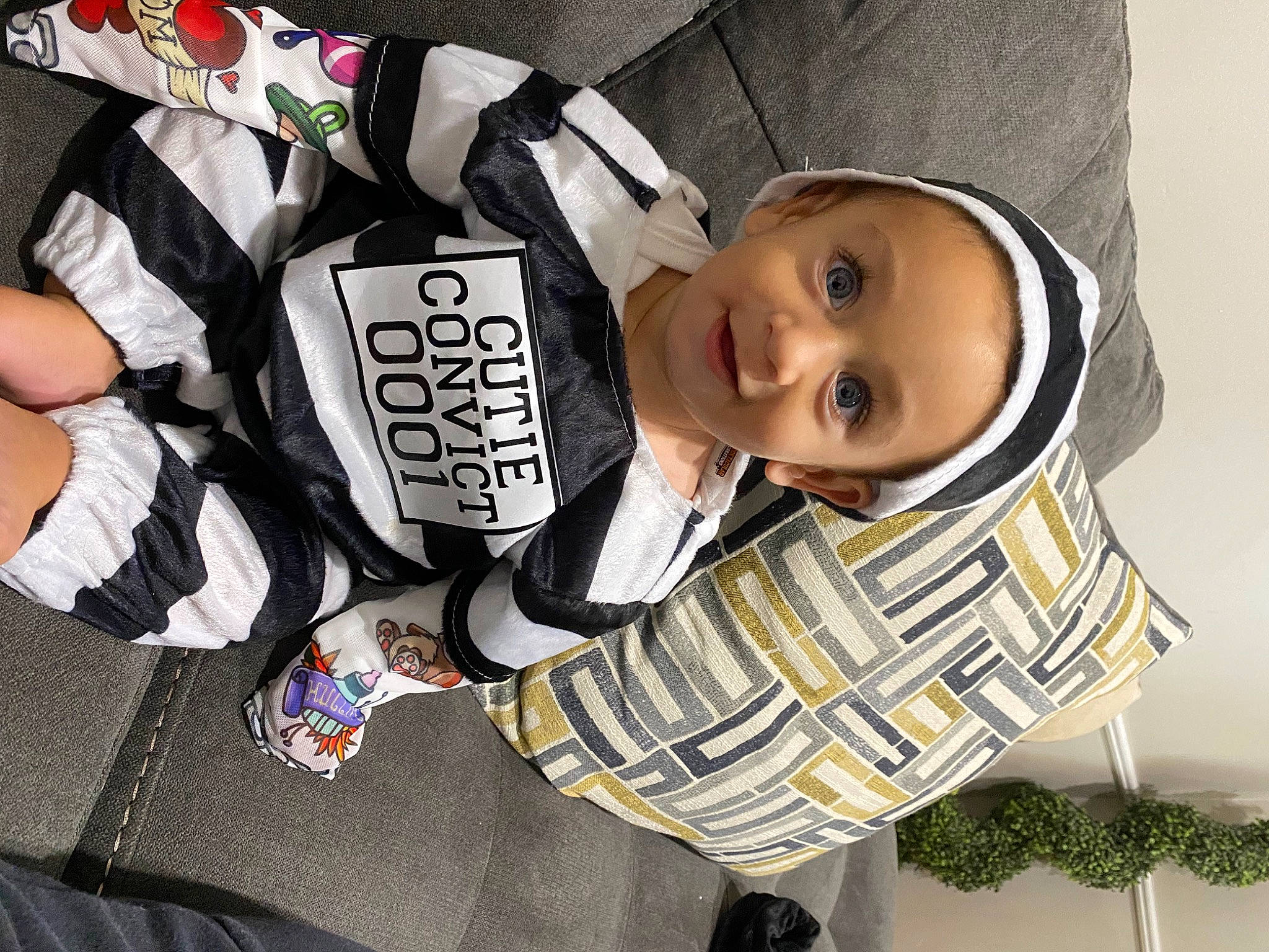 Leighton is registered to the contest to win money with this photo: baby, baby_products, baby_toddler_clothing, cap, carmine, child, comfort, cool, facial_expression, fashion_accessory, fun, happy, hat, outerwear, pattern, person, plant, sleeve, smile, textile