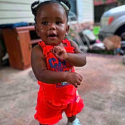 Solai joined the competition — help win amazing prizes! building, car, casual, child, concrete_floor, cute, daytime, fashion, hair_puffs, outdoor, person, porch, portrait, red_clothing, smiling, sneakers, standing, toddler, window, young_child