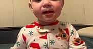 Jason joined the competition — help win amazing prizes! toddler, child, pajamas, reindeer, holiday, bed, indoor, smile, face, person, clothing, cute, sitting, young_child, cozy, winter, festive, red, white, wall