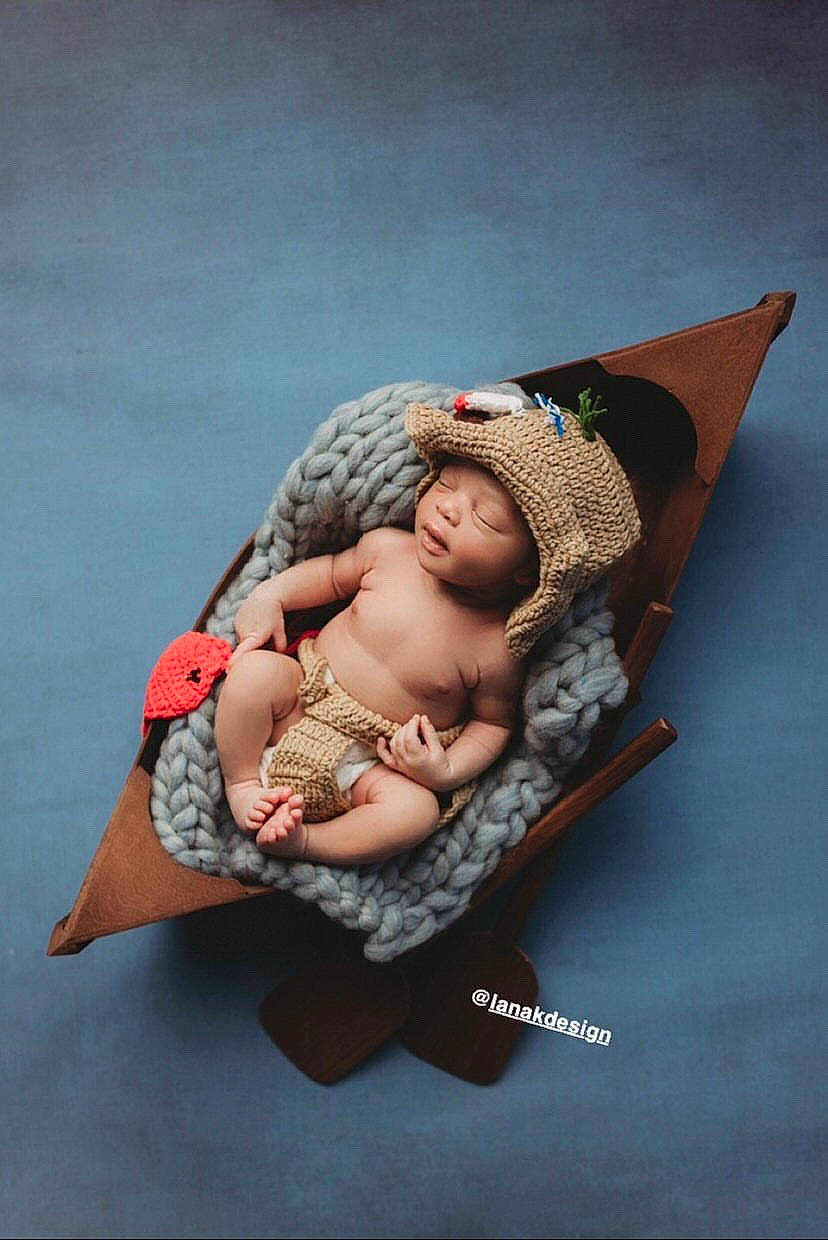 Karsen is registered to the contest to win money with this photo: abdomen, art, baby, baby_products, baby_sleeping, baby_toddler_clothing, beanie, cap, chest, child, comfort, fashion_accessory, fedora, headgear, headwear, jewellery, linens, pattern, person, sitting