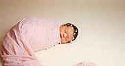 Oakland joined the competition — help win amazing prizes! newborn, baby, sleeping, pink_blanket, pearl_decorations, headpiece, swaddled, portrait, infant, soft_texture, closeup, peaceful, cute, studio, neutral_background, delicate, resting, small, wrapped, adorable