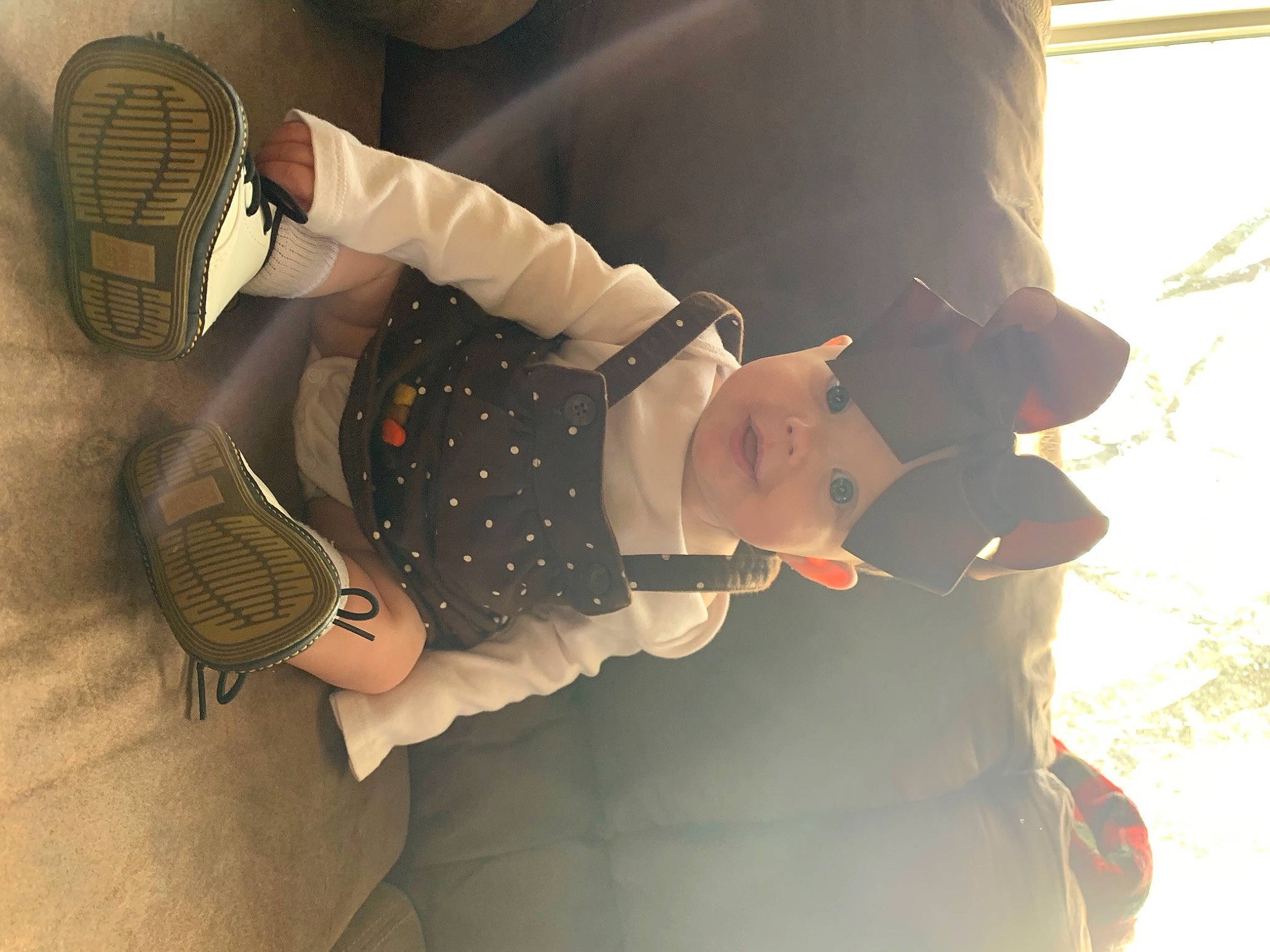 Aubree is registered to the contest to win money with this photo: audio_equipment, child, comfort, eyewear, fun, gesture, happy, hat, headgear, headwear, human_leg, knee, mechanical_fan, pattern, person, personal_protective_equipment, room, sun_hat, thigh, tree