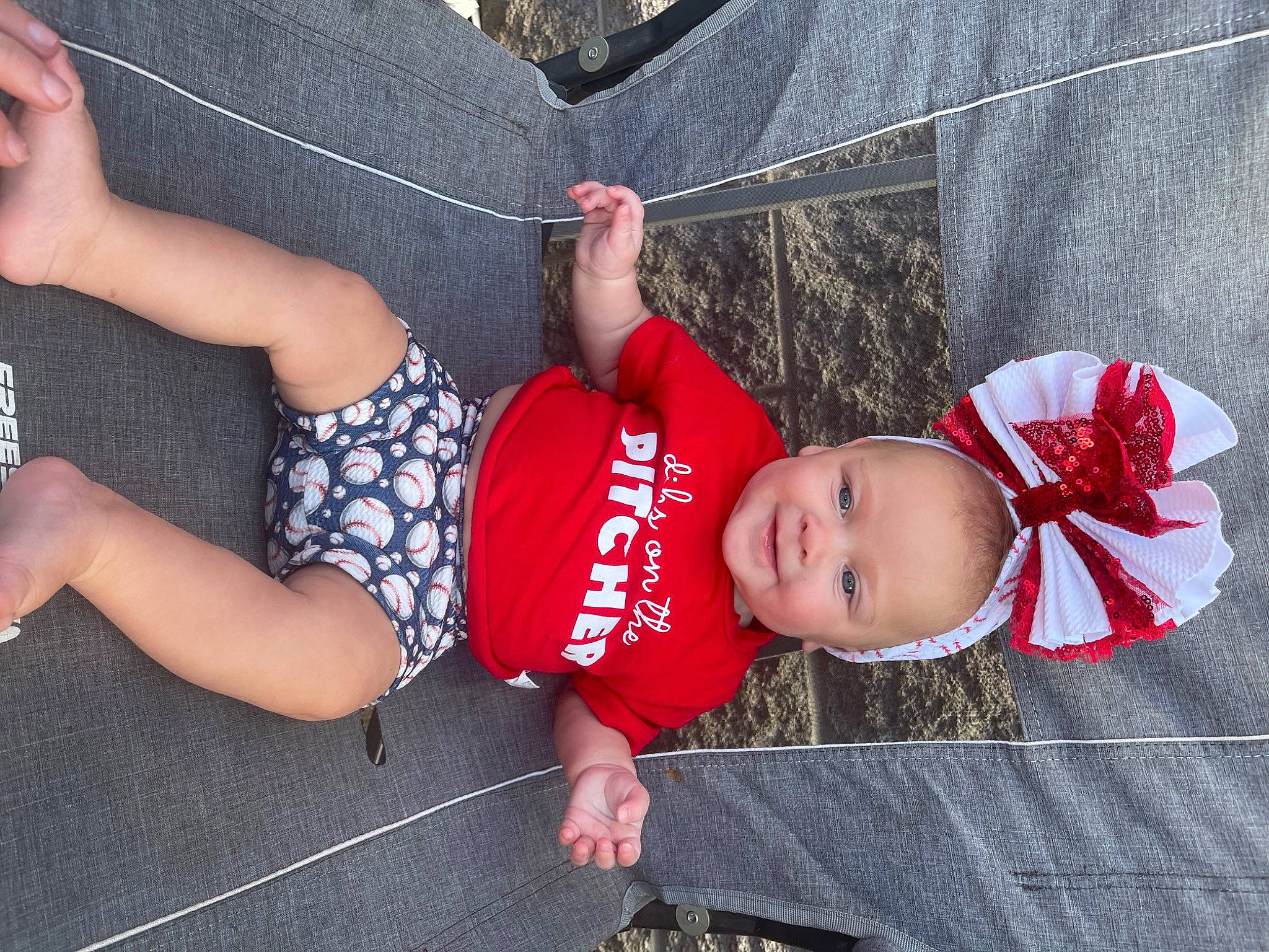 Rowan is registered to the contest to win money with this photo: baby, baby_toddler_clothing, child, comfort, foot, fun, grass, happy, hat, human_leg, knee, lap, leg, leisure, person, shorts, sitting, sock, thigh, toddler