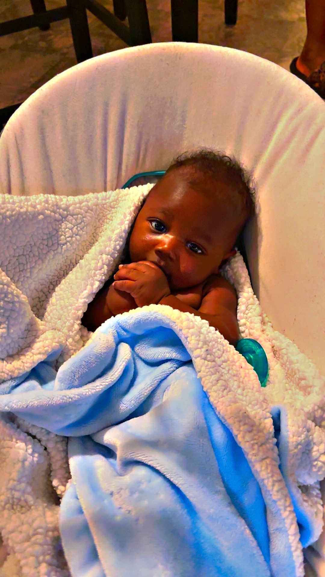 Ahdyssea is registered to the contest to win money with this photo: baby, blanket, blue_blanket, cushion, infant, pacifier, seat, child, hand, face, curious, cozy, indoor, wrapped, soft_texture, skin, portrait, comfort, young_child, resting