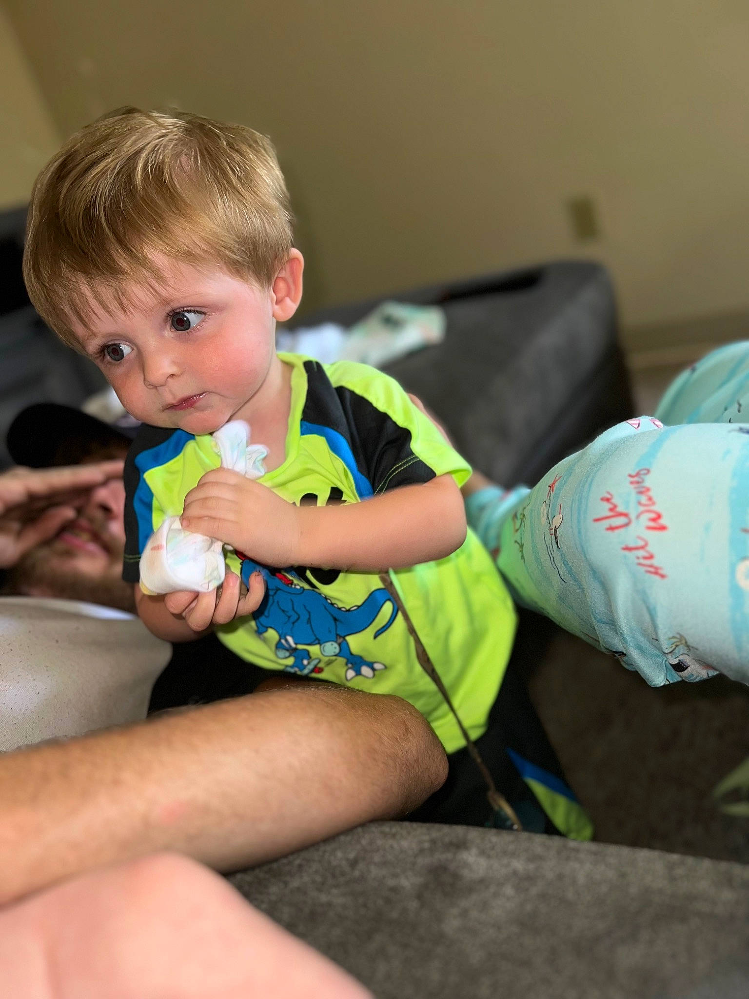 Weston is registered to the contest to win money with this photo: baby, baby_toddler_clothing, child, comfort, couch, flooring, foot, fun, happy, human_leg, joint, knee, lap, leisure, person, play, room, sitting, t_shirt, thigh