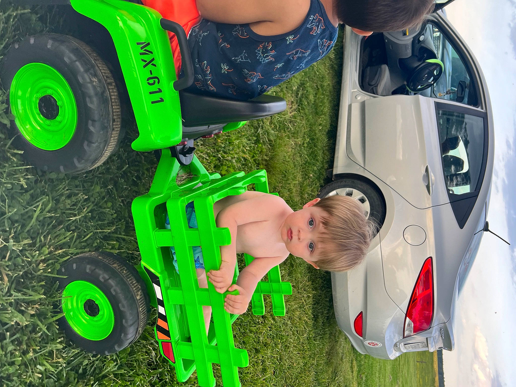 Weston is registered to the contest to win money with this photo: automotive_design, automotive_exterior, automotive_tire, car, grass, green, hood, mode_of_transport, motor_vehicle, person, photograph, plant, product, rim, synthetic_rubber, tire, tread, vehicle, vehicle_door, wheel