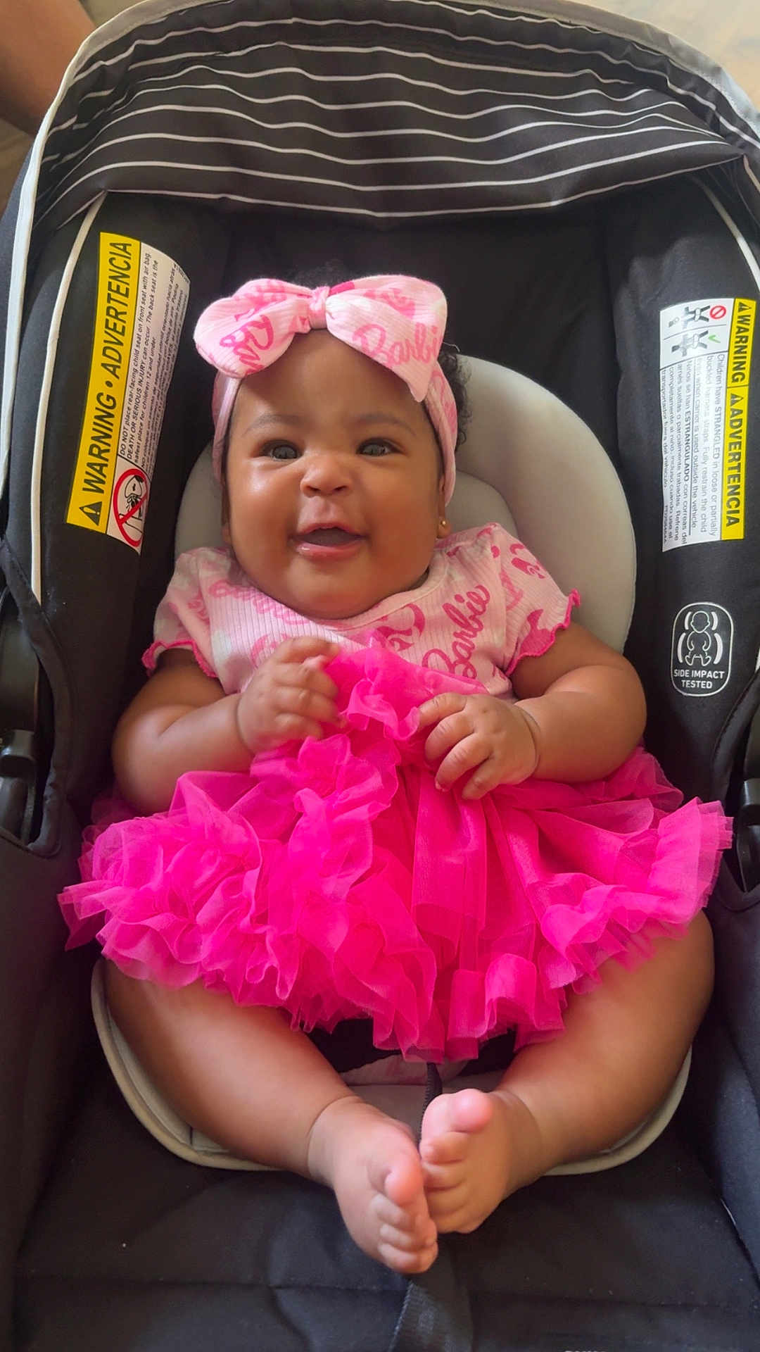 Pryceless joined the competition — help win amazing prizes! baby, child, infant, car_seat, pink_tutu, headband, smiling, cute, happy, legs, feet, clothing, seat, safety, warning_label, adorable, portrait, indoor, person, baby_girl