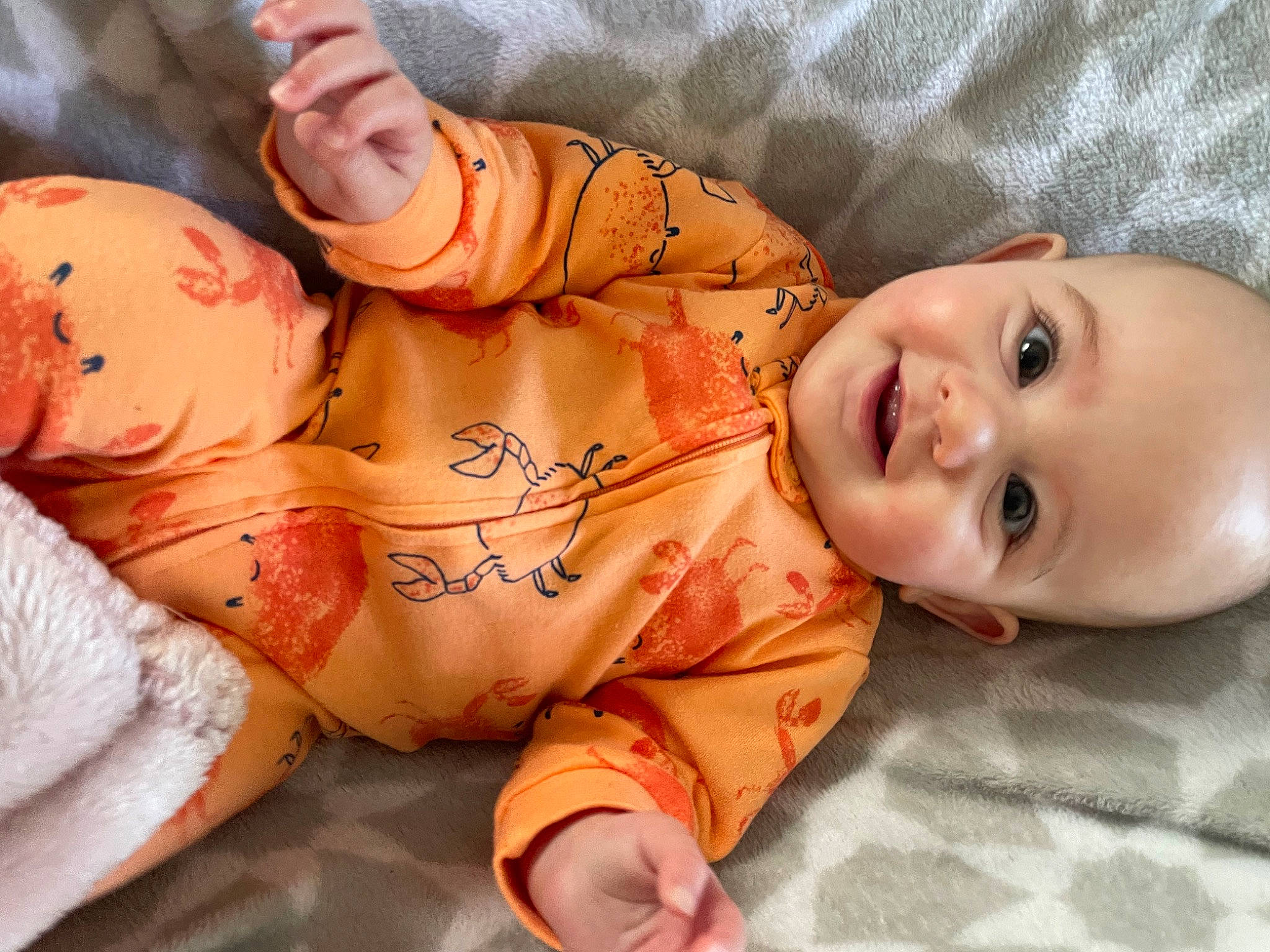 Kaia is registered to the contest to win money with this photo: baby, baby_toddler_clothing, cheek, chest, comfort, dress, eye, finger, gesture, hair, hand, human_body, lip, mouth, nose, person, skin, smile, stomach, thumb
