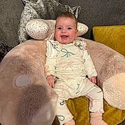 Andie joined the competition — help win amazing prizes! baby, child, comfort, couch, cozy, cushion, cute, furniture, happy, home, indoor, infant, pajamas, person, pink, plush, seated, smiling, soft, yellow