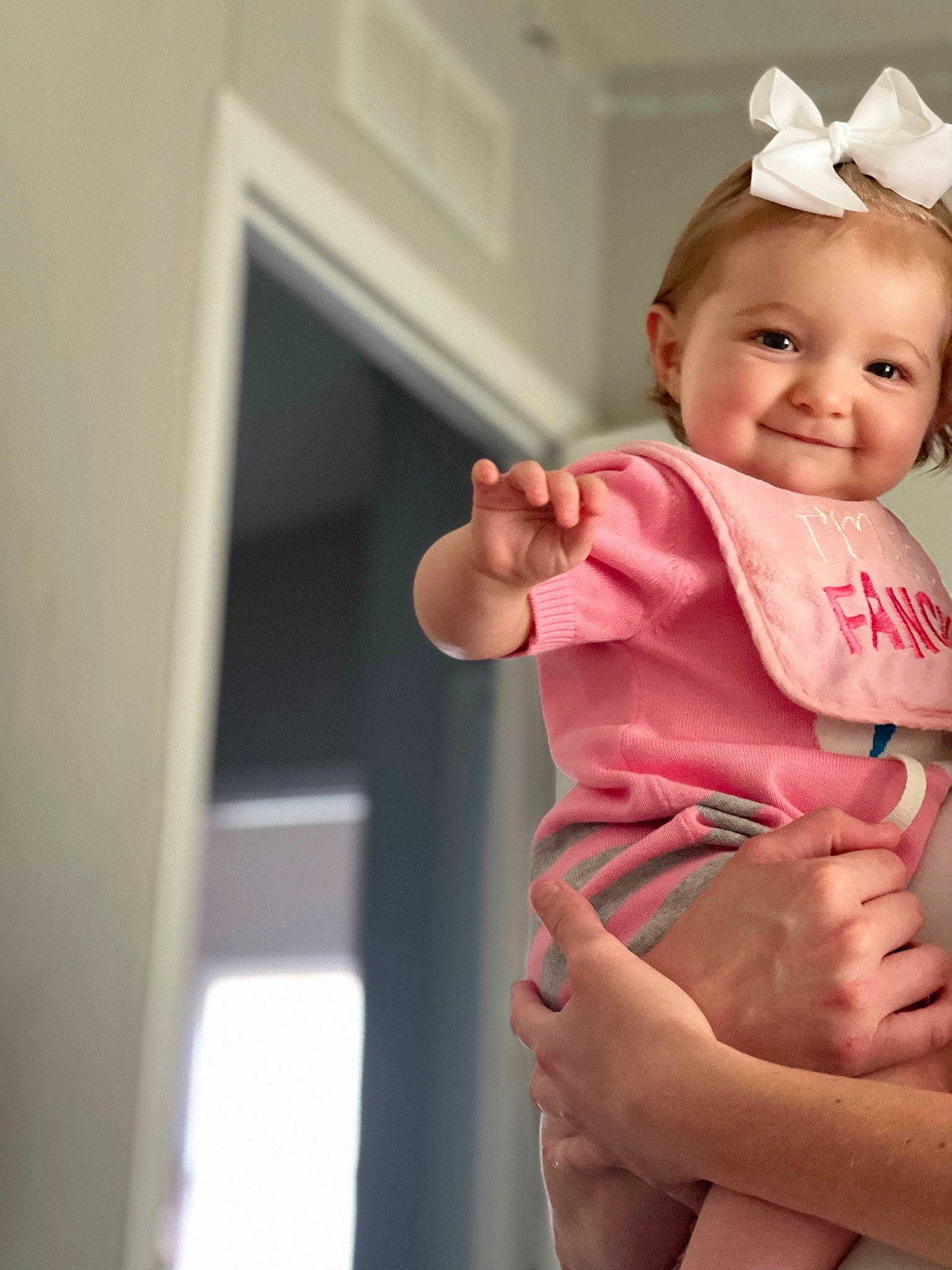 Remi is registered to the contest to win money with this photo: baby, baby_toddler_clothing, cheek, dress, elbow, eye, foot, gesture, hand, happy, human_leg, joy, knee, person, skin, sleeve, smile, stomach, thigh, thumb