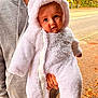 baby, child, person, hooded_clothing, adult, outdoor, fall, leaves, road, trees, greenery, coat, zipper, hand, beard, casual_clothing, cute, warm_clothing, expression, holding