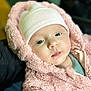 Esmée participe au concours pour gagner de l'argent avec cette photo : baby, infant, newborn, hat, hood, pink_fleece, jacket, cozy, close_up, portrait, face, blue_eyes, soft_texture, warm_clothing, cute, skin, lips, plush, bokeh, person
