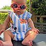 baby, child, sunglasses, outdoor, summer, cute, sitting, clothing, minnie_mouse, greenery, bench, fence, sunlight, portrait, foot, hand, head, face, table, fashion