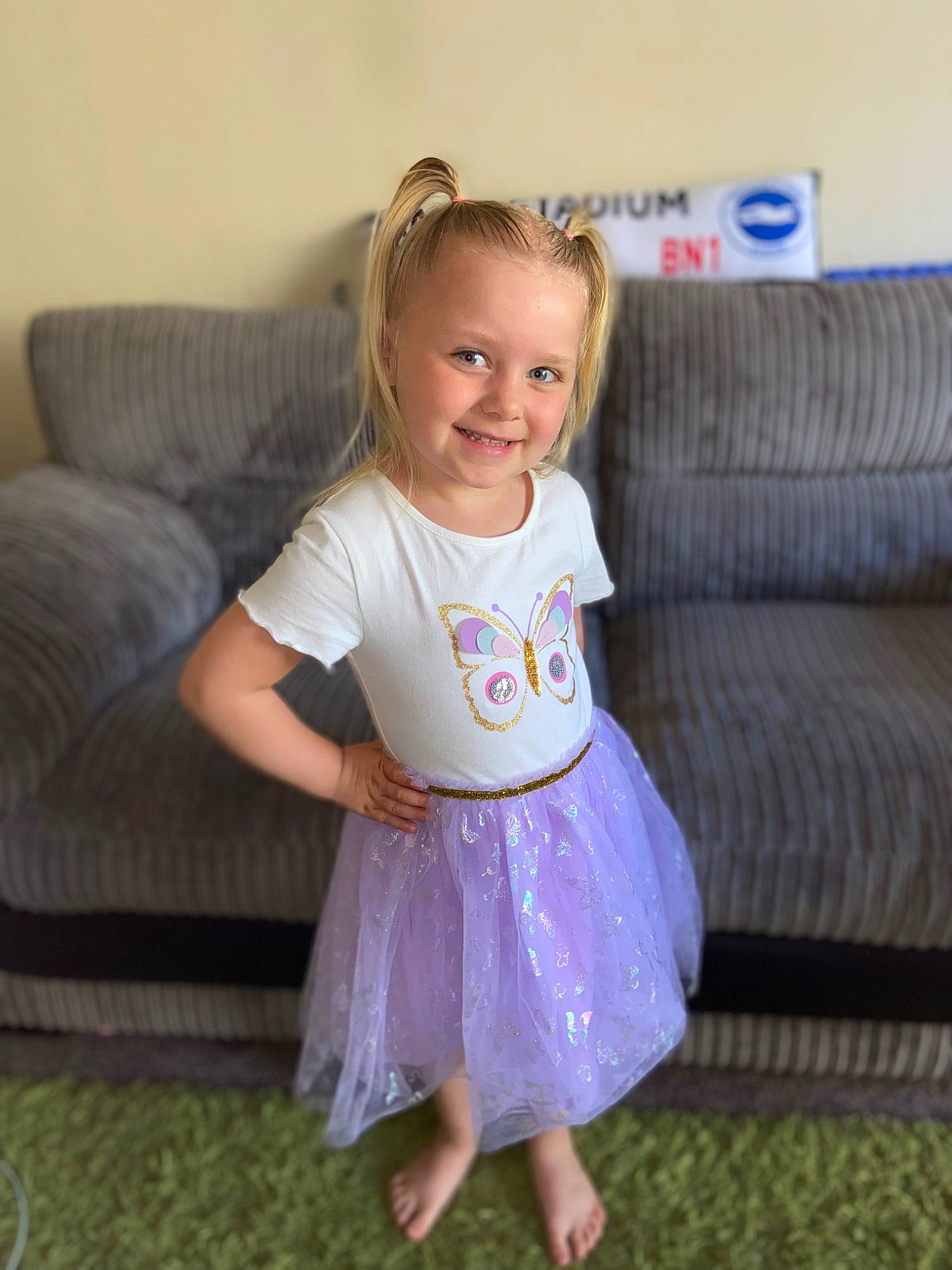 Daisie is registered to the contest to win money with this photo: baby_toddler_clothing, comfort, couch, dress, face, facial_expression, hair, hairstyle, happy, human_body, iris, joy, person, pink, purple, shoulder, skin, sleeve, smile, t_shirt