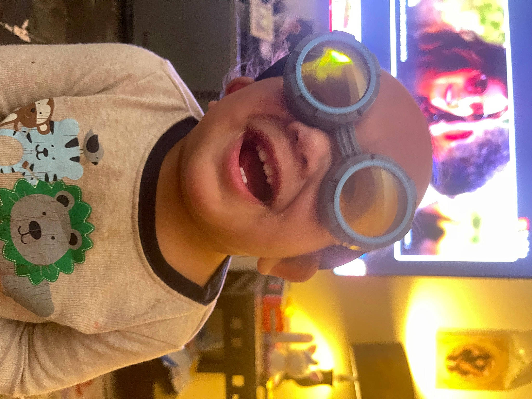 Leonel joined the competition — help win amazing prizes! animation, audio_equipment, automotive_lighting, baby, child, eyewear, fun, goggles, green, happy, headwear, human, joy, leisure, mouth, nose, person, personal_protective_equipment, room, smile