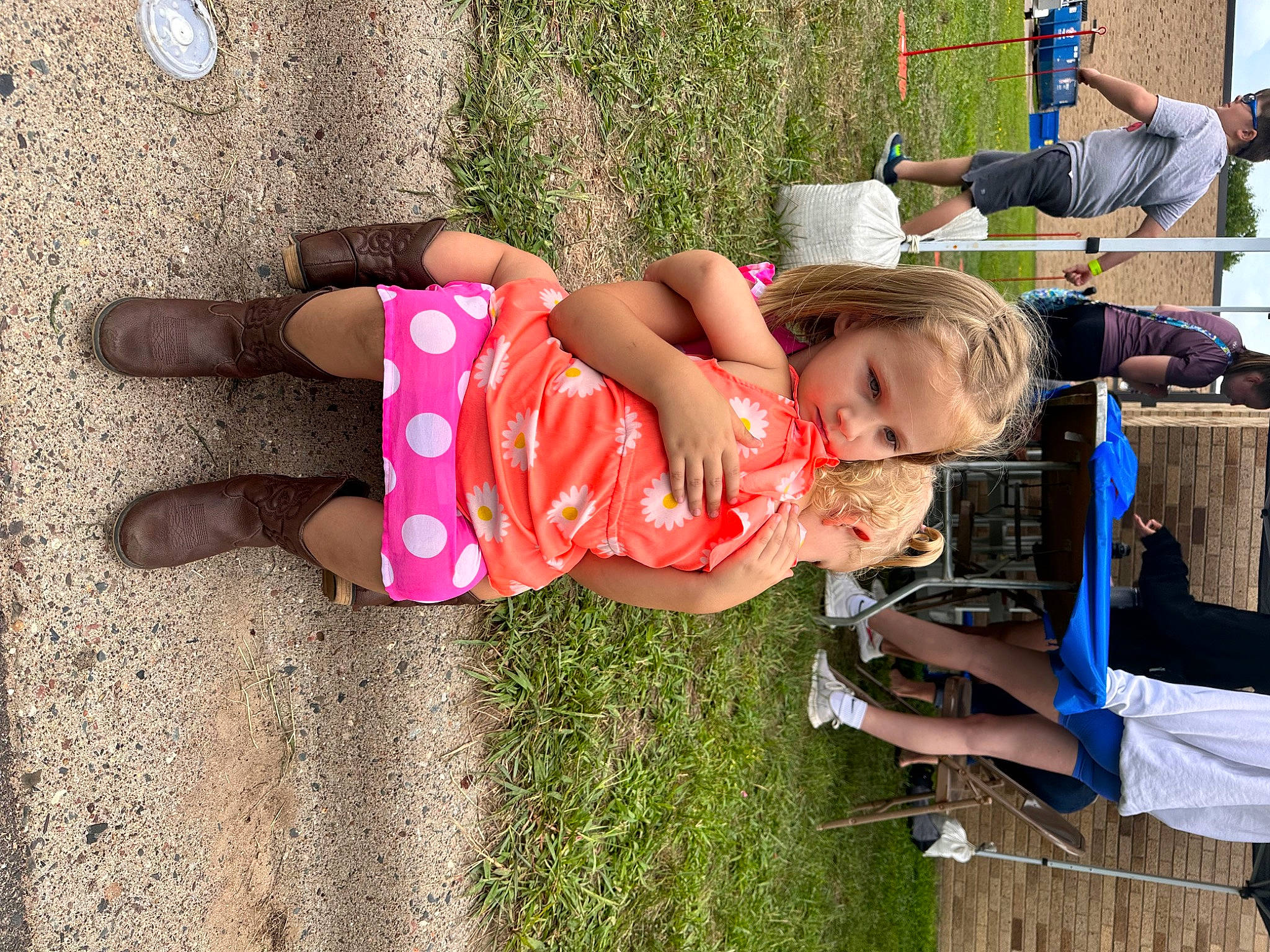 Eleanor is registered to the contest to win money with this photo: arm, barefoot, child, foot, fun, grass, happy, human_leg, leisure, people_in_nature, person, plant, play, recreation, sandal, shorts, sitting, t_shirt, thigh, toddler