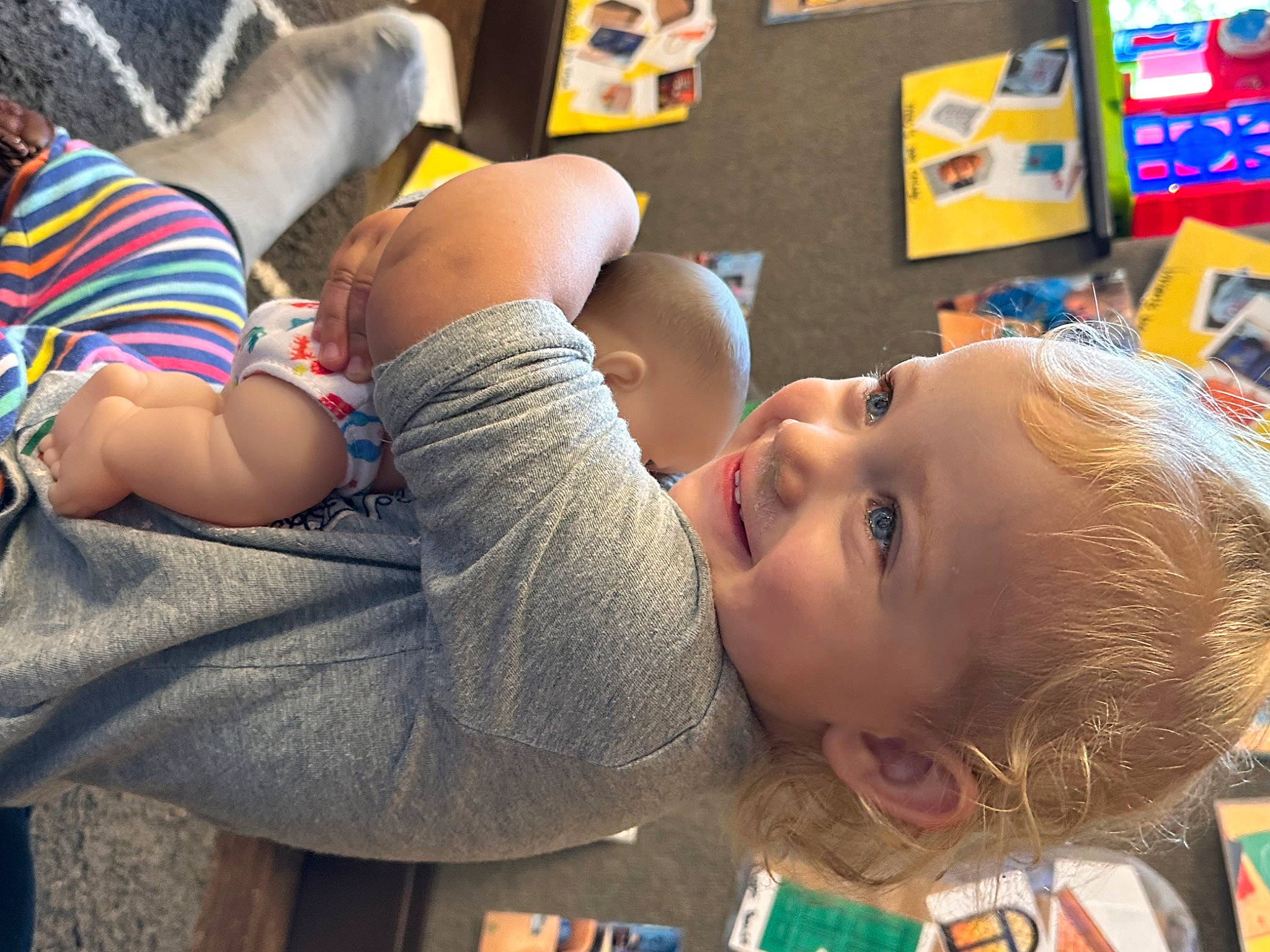 Lily Ann is registered to the contest to win money with this photo: baby, baby_toddler_clothing, cheek, child, facial_expression, flooring, fun, grass, happy, joy, kindergarten, leisure, mammal, person, play, product, room, shelf, sitting, thigh