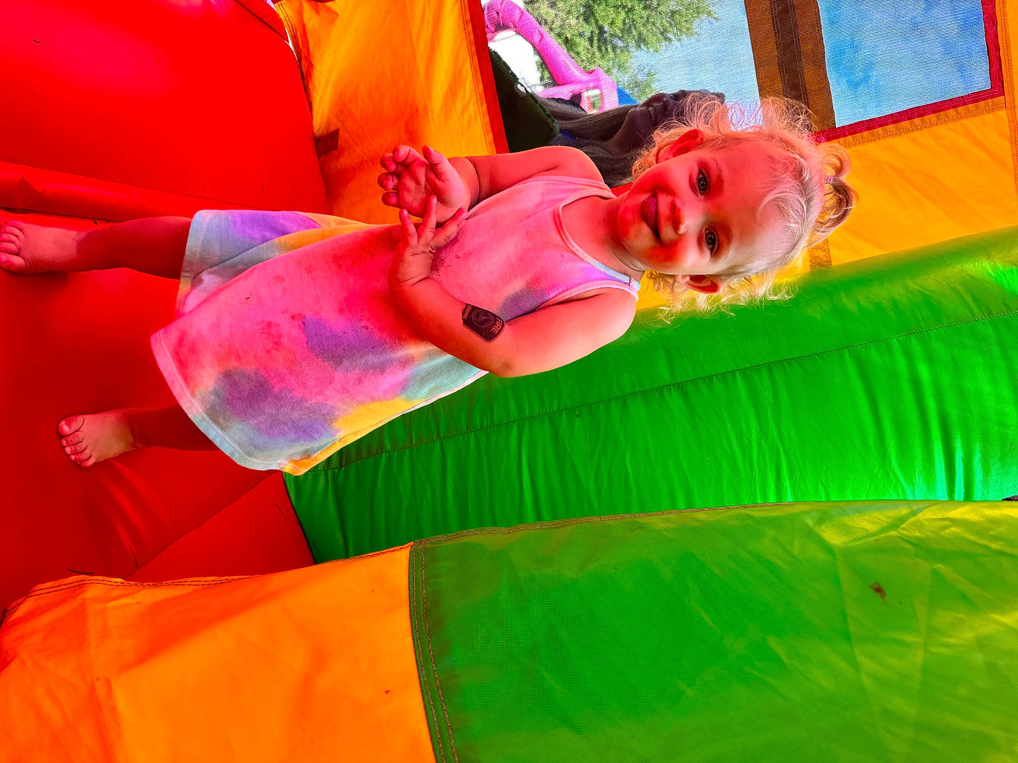 Lily Ann joined the competition — help win amazing prizes! bounce_house, child, event, fun, grass, green, happy, joy, leisure, magenta, orange, outdoor_play_equipment, person, pink, plant, play, playground, recreation, smile, toddler