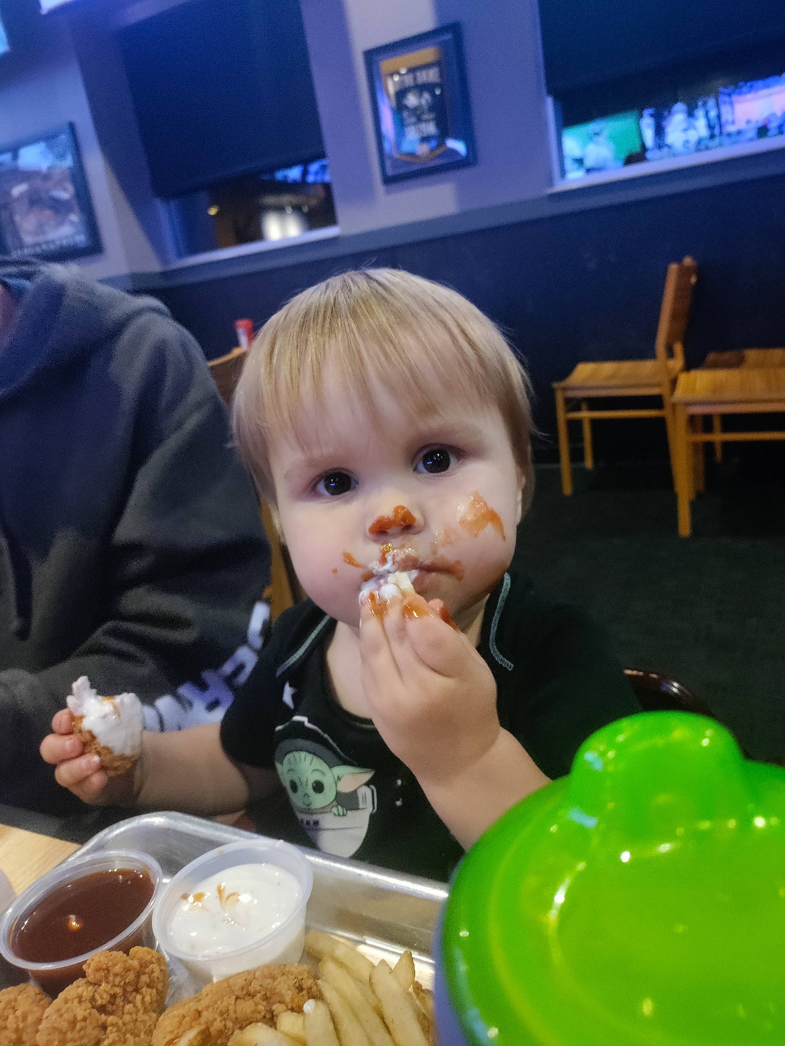 Troy is registered to the contest to win money with this photo: balloon, blue, chair, child, comfort_food, cooking, cuisine, dish, food, food_craving, french_fries, ingredient, junk_food, person, picture_frame, plate, sharing, table, tableware, television