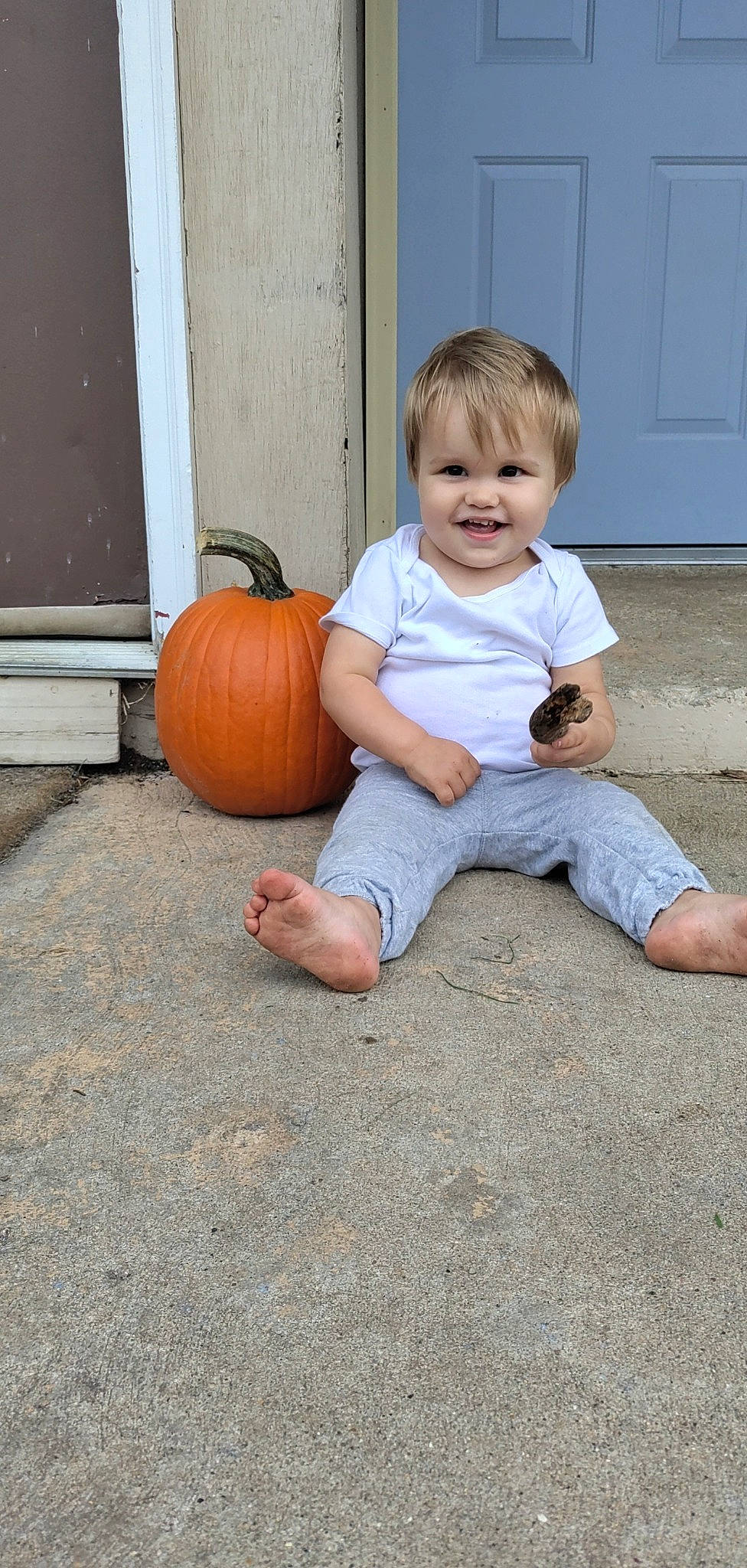Troy is registered to the contest to win money with this photo: calabaza, cucurbita, door, eye, face, floor, flooring, gourd, hair, head, human_body, joy, leg, people, person, plant, pumpkin, smile, squash, toddler