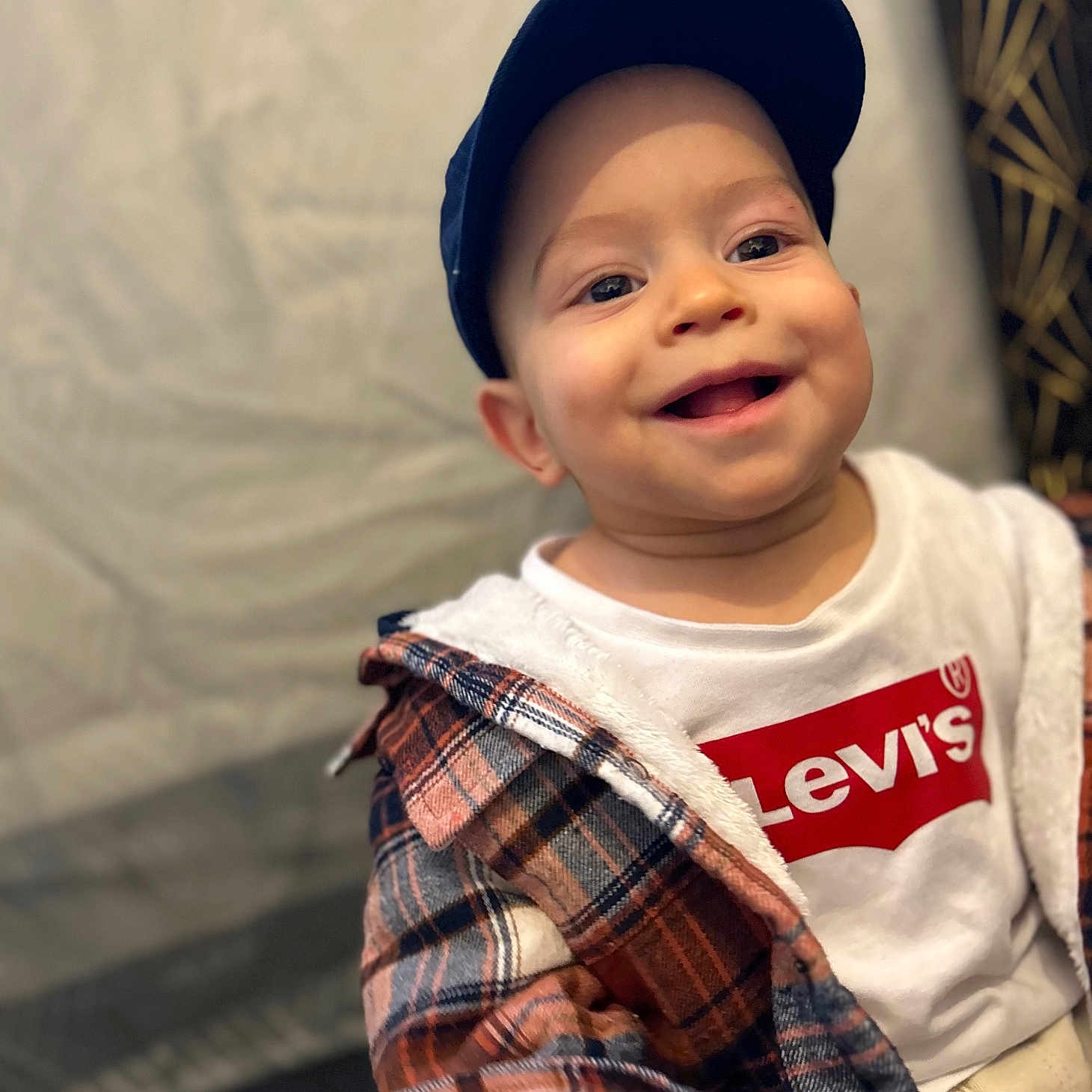 Karim a rejoint le concours — aidez-le/la à gagner de superbes lots ! baby, cap, casual_wear, child, clothing, cute, expression, face, fashion, happy, headwear, indoor, person, plaid_jacket, portrait, smiling, toddler, warm_lighting, white_shirt, young_child