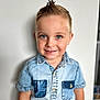 blue_eyes, boy, button_up, casual_clothing, child, cute, denim_shirt, face, fashion, hairstyle, happy, indoor, light_background, mohawk, person, portrait, short_sleeves, smile, standing, young