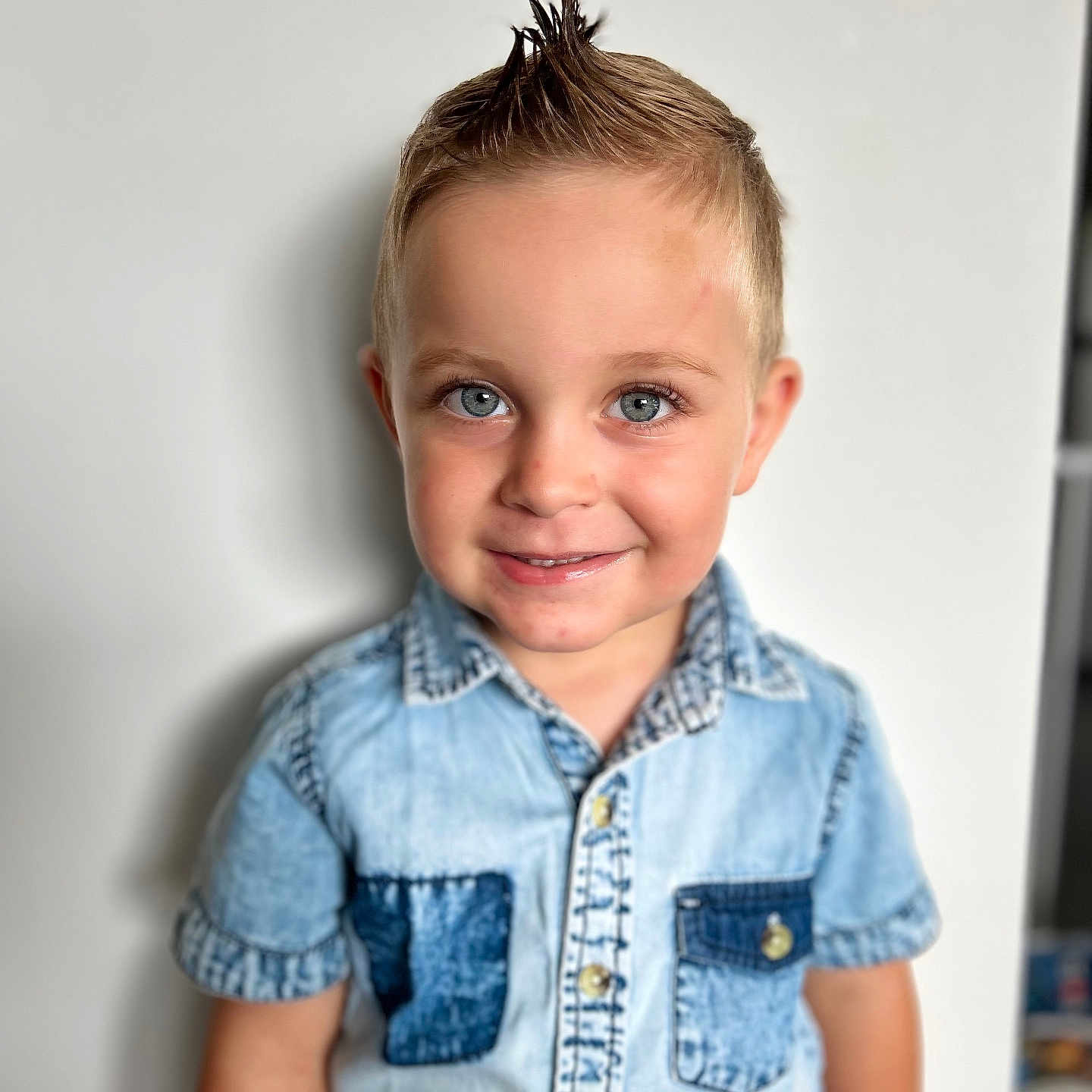 Rodrigo participe au concours pour gagner de l'argent avec cette photo : blue_eyes, boy, button_up, casual_clothing, child, cute, denim_shirt, face, fashion, hairstyle, happy, indoor, light_background, mohawk, person, portrait, short_sleeves, smile, standing, young