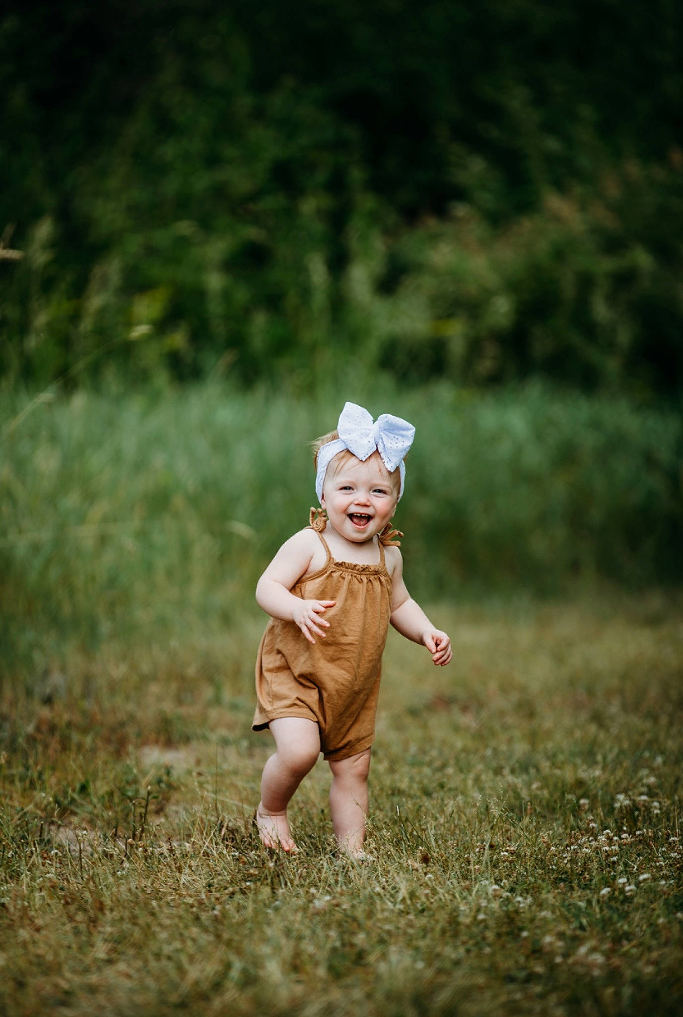 Bexley is registered to the contest to win money with this photo: baby, fawn, flash_photography, forest, gesture, grass, grassland, happy, hat, headwear, joy, landscape, meadow, people_in_nature, person, personal_protective_equipment, plant, prairie, smile, soil