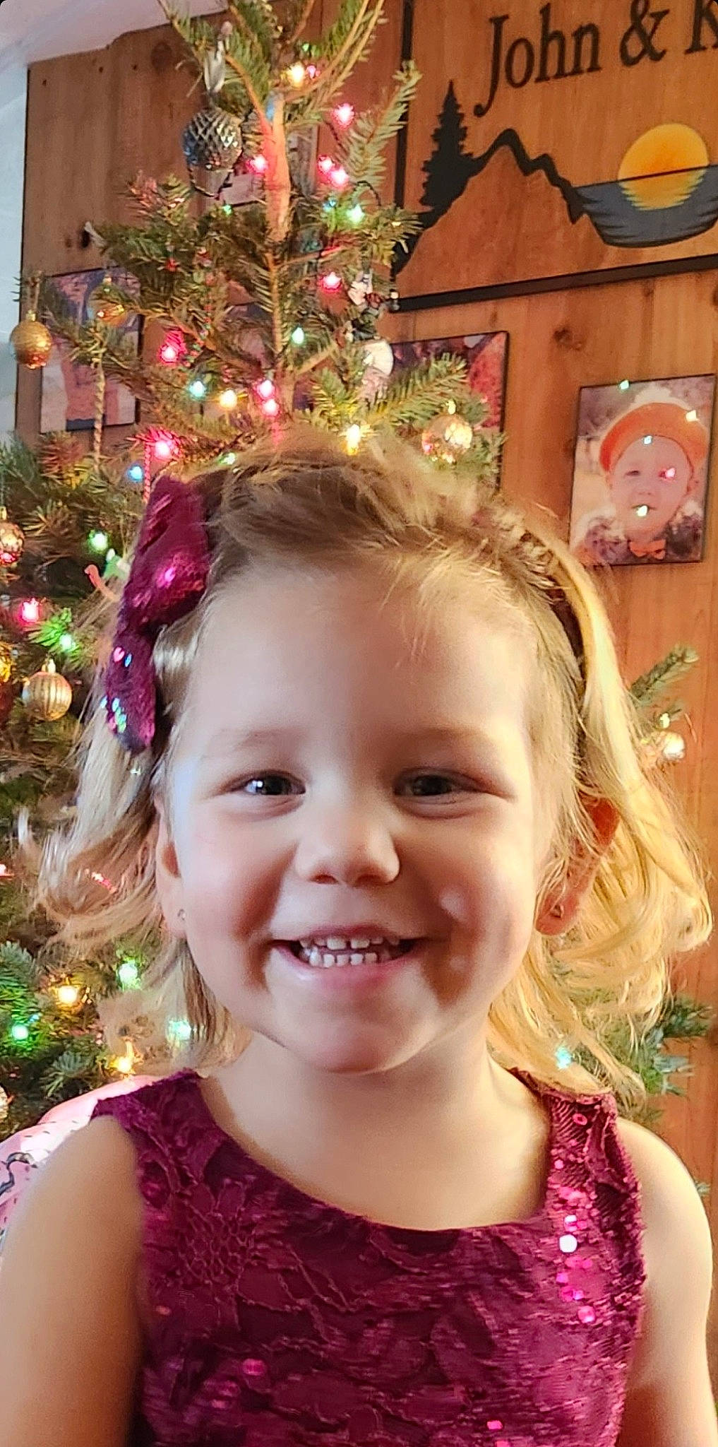 Dallas is registered to the contest to win money with this photo: blond, cheek, child, christmas_decoration, christmas_ornament, christmas_tree, event, eye, fun, green, happy, holiday_ornament, iris, joy, ornament, person, photograph, pink, plant, smile