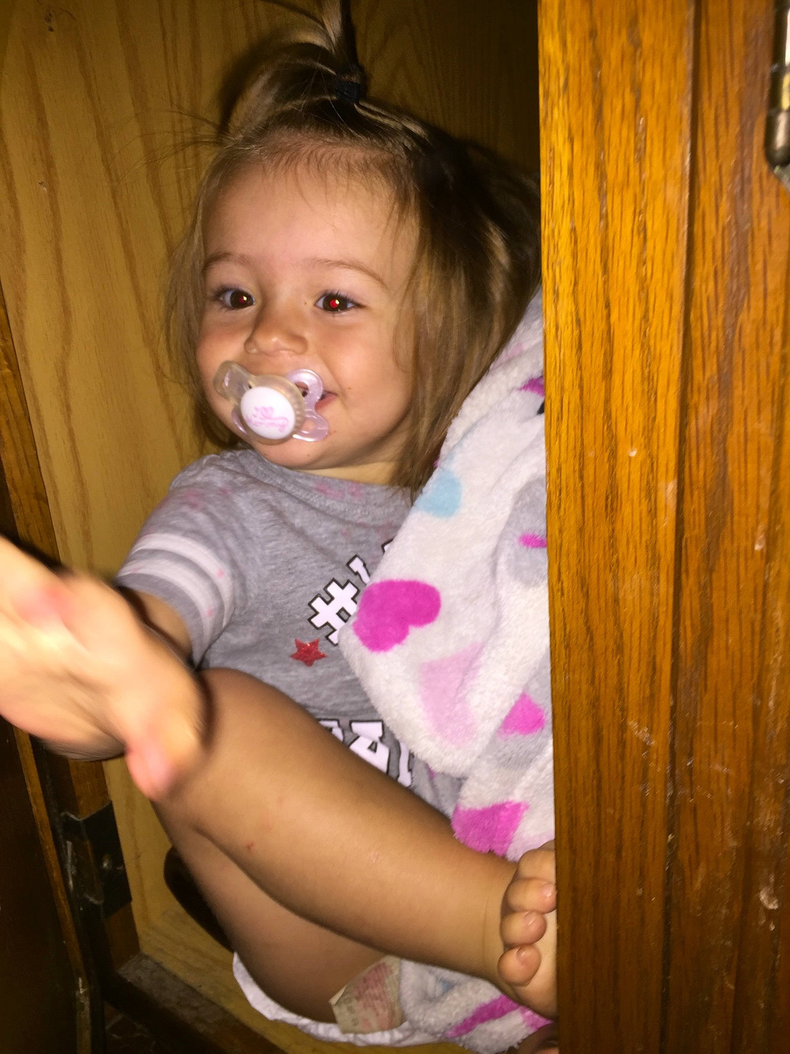 Whisper is registered to the contest to win money with this photo: arm, baby, cheek, child, chin, eye, face, finger, fun, hair, iris, joy, leg, long_hair, nose, person, pink, sitting, skin, smile