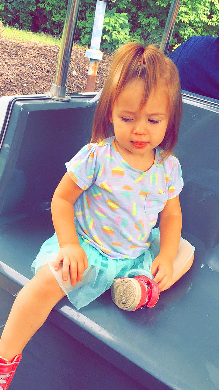 Whisper is registered to the contest to win money with this photo: baby, child, child_model, daughter, fun, happy, leg, outdoor_play_equipment, person, pink, plant, play, playground, recreation, sitting, skin, smile, summer, swing, toddler